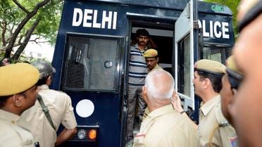 Akshay Thakur (top), one of the four men who were sentenced to death for the rape and murder of a young woman on a bus December 2012, disembarks a police vehicle outside a court in New Delhi September 24, 2013. (Reuters)