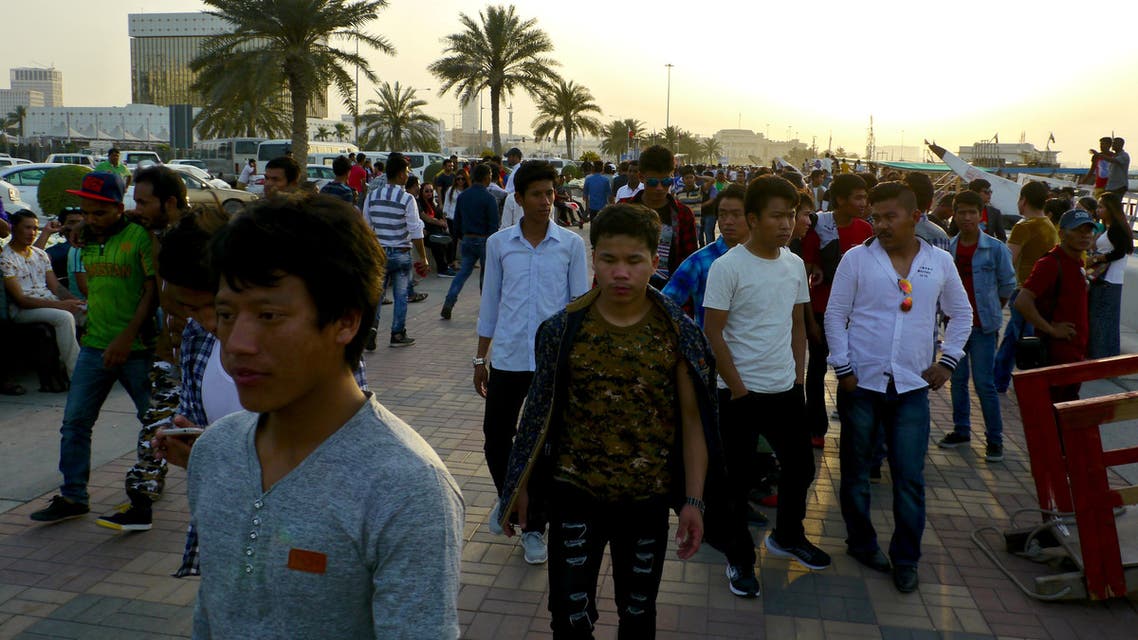 Migrant workers walk on the corniche in Doha, Qatar April 14, 2017. (Reuters)