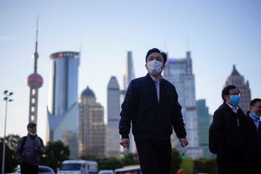 People wear protective face masks, following an outbreak of the novel coronavirus, at Lujiazui financial district in Shanghai, China, March 19, 2020. (File photo: Reuters)