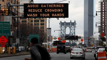 Signage regarding the coronavirus disease (COVID-19) is displayed at the entrance to the Manhattan Bridge in the Brooklyn borough of New York City, US, March 20, 2020. (Reuters)