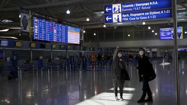 Passengers wearing protective face masks make their way at the Athens International airport, following an outbreak of the coronavirus disease (COVID-19), in Athens, Greece, March 21, 2020. REUTERS/Alkis Konstantinidis