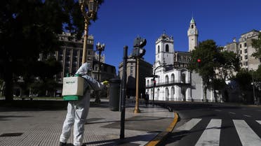 A worker disinfects Plaza de Mayo after Argentina's President Alberto Fernandez announced a mandatory quarantine as a measure to curb the spread of coronavirus disease (COVID-19), in Buenos Aires, Argentina March 20, 2020. REUTERS/Matias Baglietto
