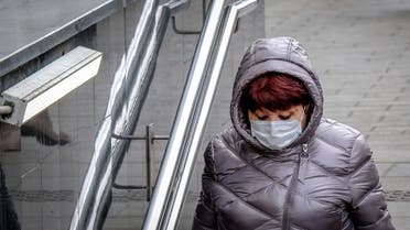 A woman wearing a face mask, amid concerns of the COVID-19 coronavirus, walks in Moscow on March 23, 2020. (AFP)