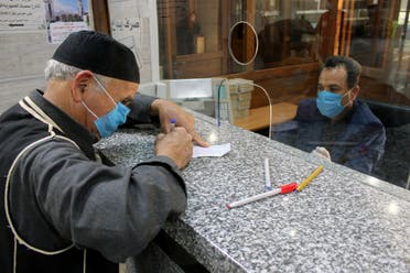 Men wear face masks in Libya amid the coronavirus crisis on March 22, 2020. (Reuters)