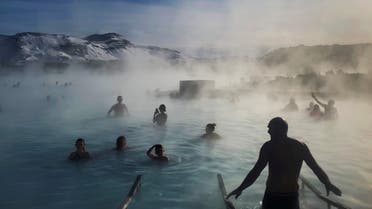 Bathers enjoy the warm volcanic hot springs of the Blue Lagoon in Grindavik, Iceland, March 6, 2020. (Reuters)
