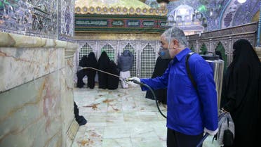 An Iranian sanitary worker disinfects Qom's Masumeh shrine on February 25, 2020 to prevent the spread of the coronavirus which reached Iran, where there were concerns the situation might be worse than officially acknowledged.
