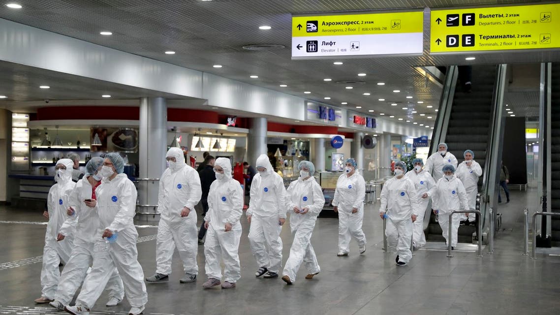 Russian medical experts walk to start their shift to check passengers arriving from foreign countries at Sheremetyevo airport outside Moscow, Russia. (AP)