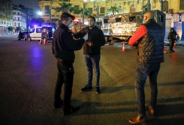 A police officer debriefs a man, near Tahrir square during the first day of a two-weeks night-time curfew in Cairo. (Reuters)