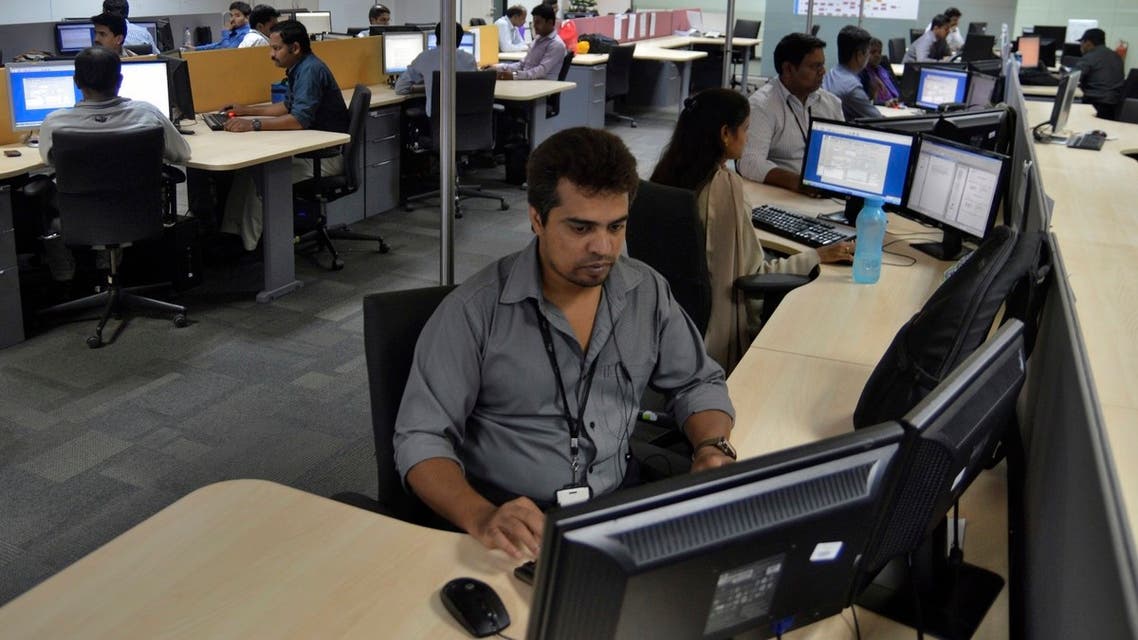 Employees of ISGN work at their stations inside the company headquarters in the southern Indian city of Bangalore June 11, 2014. (Reuters)