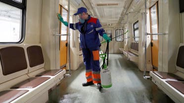 A worker sprays disinfectant in a metro train due to the outbreak of the coronavirus disease (COVID-19), in Moscow, Russia March 25, 2020. REUTERS/Evgenia Novozhenina
