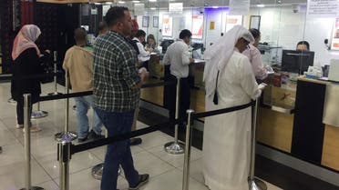 People exchange money at a money exchange office in Doha, Qatar, June 11, 2017. (File photo Reuters)