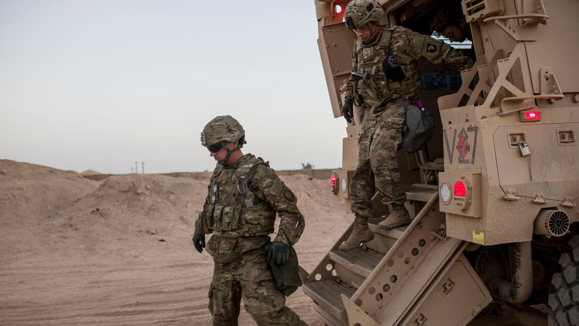 A photo taken on October 20, 2016 shows US soldiers getting out of a military vehicle at the Qayyarah military base during the ongoing operation to recapture the last major Iraqi city under the control of the Islamic State (IS) group jihadists. Just months after its recapture from the Islamic State group, the sprawling Qayyarah base in north Iraq has become a hub for operations to retake Mosul from the jihadists.