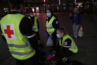 Members of the Belgian Red Cross carry food and drinks for homeless people near Brussels Central Station during the coronavirus lockdown imposed by the Belgian government in an attempt to slow down the coronavirus, in Brussels, Belgium March 25, 2020. (Reuters)