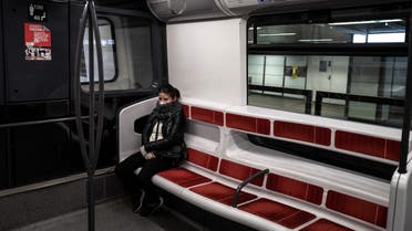 A woman sits on a metro car on March 20, 2020 in Lyon on the fourth day of a strict lockdown to stop the spread of COVID-19, caused by the novel coronavirus. (AFP)