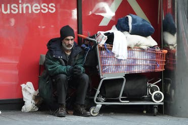 A homeless person sits with his belongings during the outbreak of Coronavirus disease, in the Manhattan borough of New York City on March 26, 2020. (Reuters) 