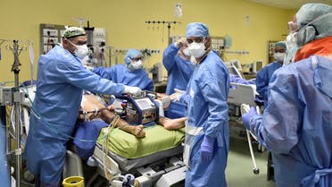 Members of the medical staff in protective suits treat a patient suffering from coronavirus disease (COVID-19) in an intensive care unit at the San Raffaele hospital in Milan, Italy. (Reuters)