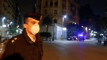 A police officer stands near Tahrir square during the first day of a two-weeks night-time curfew which was ordered by the Egyptian Prime Minister Mostafa Madbouly to contain the spread of the coronavirus disease (COVID-19), in Cairo, Egypt March 25, 2020. REUTERS/Mohamed Abd El Ghany