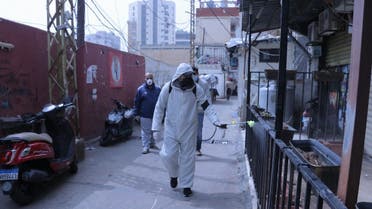 A man in a hazmat suit disinfects the Mar Elias Palestinian refugee camp in Beirut, Lebanon. (Ayham Alsahli.)