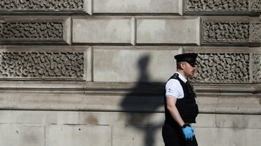 A police officer wearing gloves walks in Westminster, as the spread of coronavirus disease (COVID-19) continues. London, Britain, March 25, 2020. REUTERS/Hannah Mckay