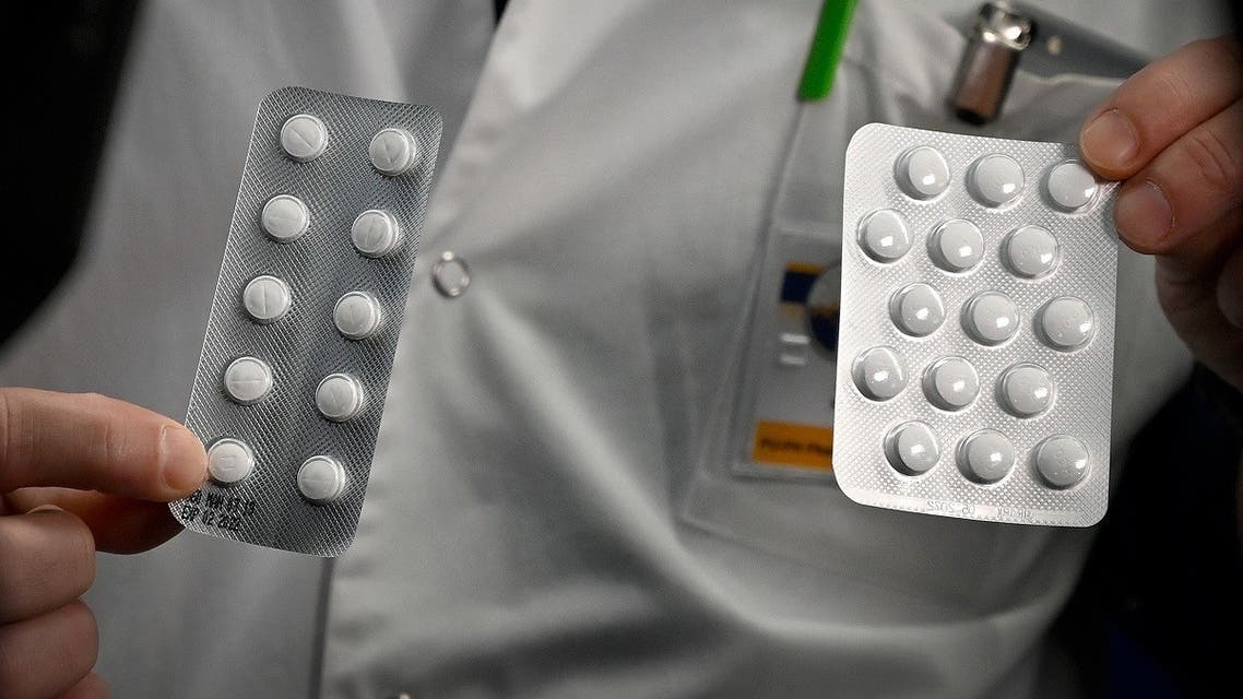 this file photo taken on February 26, 2020, medical staff shows o at the IHU Mediterranee Infection Institute in Marseille, packets of a Nivaquine, tablets containing chloroquine and Plaqueril, tablets containing hydroxychloroquine, drugs that has shown signs of effectiveness against coronavirus. (AFP)