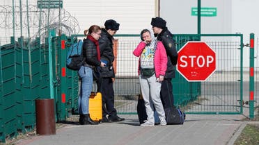 Ukrainian citizens react near Russian border guards at a crossing point in Hoptivka. (File photo: Reuters)