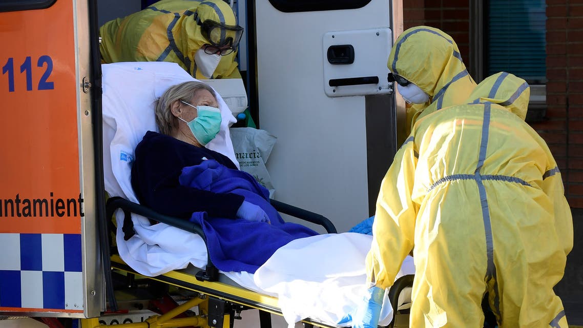 Civil Defence members carry a patient on a stretcher as they arrive at the Severo Ochoa hospital in Leganes, on March 26, 2020. Spain's coronavirus death toll surged above 4,000 today but the increase in both fatalities and new infections slowed, leaving officials hopeful a nationwide lockdown is starting to curb the spread of the disease. A total of 655 deaths were recorded in the country in the last 24 hours, bringing the toll to 4,089, the health ministry said.