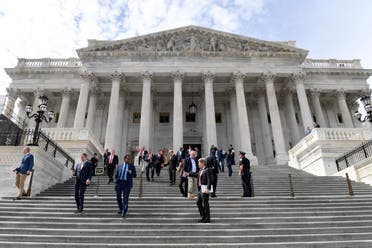 Members of the House of Representatives walk down the steps of Capitol Hill in Washington, on Friday, March 27, 2020, after passing a coronavirus rescue package. (AP)