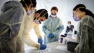 Doctors test hospital staff with flu-like symptoms for coronavirus (COVID-19) in set-up tents to triage possible COVID-19 patients. (AFP)
