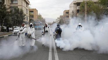 FILE PHOTO: Members of firefighters wear protective face masks, amid fear of coronavirus disease (COVID-19), as they disinfect the streets, ahead of the Iranian New Year Nowruz, March 20, in Tehran, Iran March 18, 2020. Picture taken March 18, 2020. WANA (West Asia News Agency)/Ali Khara via REUTERS ATTENTION EDITORS - THIS PICTURE WAS PROVIDED BY A THIRD PARTY/File Photo