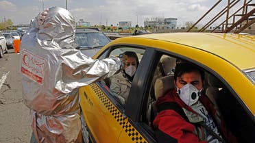 Members of the Iranian Red Crescent test people for coronavirus Covid-19 symptoms, as police blocked Tehran to Alborz highway to check every car following orders by the Iranian government, outside Tehran on March 26, 2020. Iran announced 157 new deaths from coronavirus, raising the official number of fatalities to 2,234, as it slapped a ban on intercity travel to try to curb the spread. Health ministry spokesman Kianoush Jahanpour also said that 2,389 new cases have been confirmed in the past 24 hours, bringing the total number of declared infections in one of the world's wost-hit countries to 29,406.