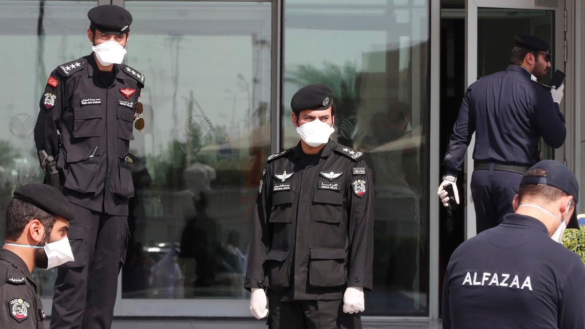 Qatari police stand outside a hotel in Doha where people have been quarantining over fears of coronavirus, on March 12, 2020. (AFP)