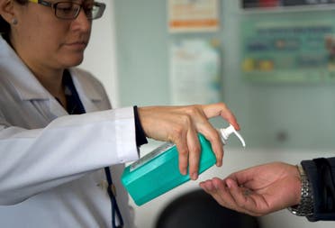 Ecuador's Health Minister personnel gives gel alcohol as a preventive measure against the spread of the coronavirus in Quito, on March 10, 2020. (AFP)
