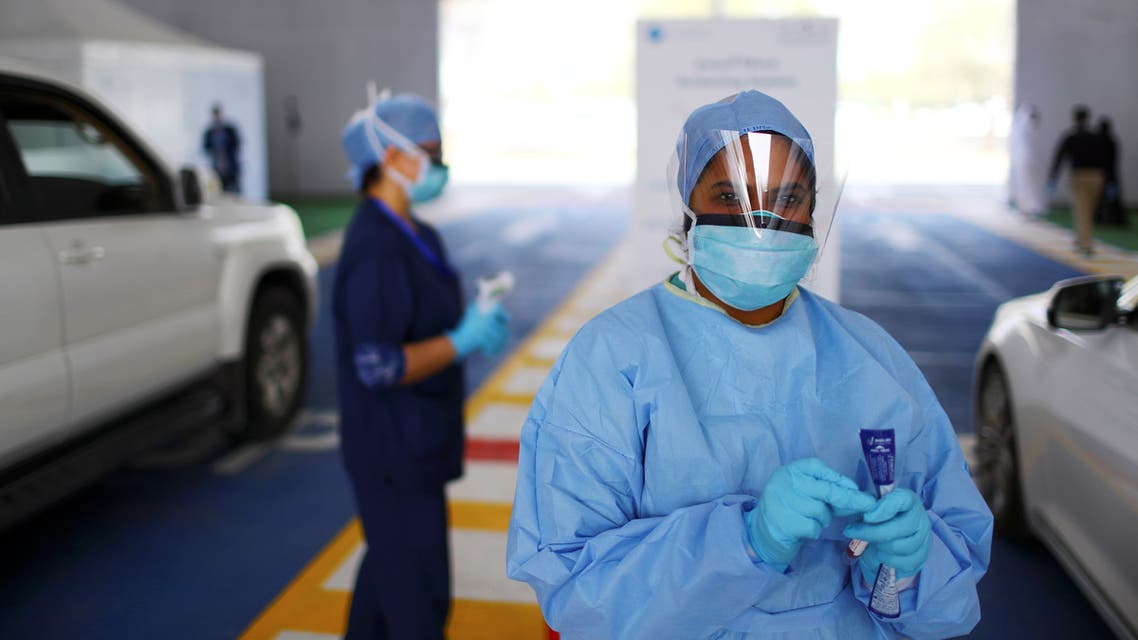 A member of medical staff looks on during drive-thru coronavirus disease testing (COVID-19) at a screening centre in Abu Dhabi, United Arab Emirates March 30, 2020. REUTERS/Ahmed Jadallah