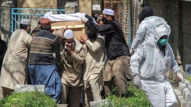 People move a coffin of a man who died due to coronavirus disease (COVID-19), for a burial at graveyard in Abbottabad, Pakistan March 29, 2020. (Reuters)