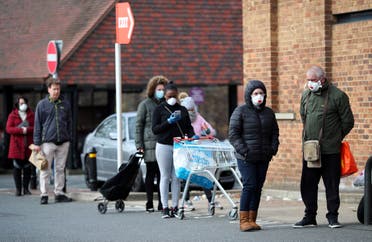 People wearing protective facemasks queue outside Sainsbury's supermarket in Streatham, as the spread of the coronavirus disease (COVID-19) continues, London, Britain, March 29, 2020. (Reuters)