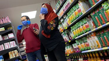 A family with protective masks is seen at a market before the start of night-time curfew to contain the spread of the coronavirus disease (COVID-19) in Cairo, Egypt March 29, 2020. REUTERS/Amr Abdallah Dalsh