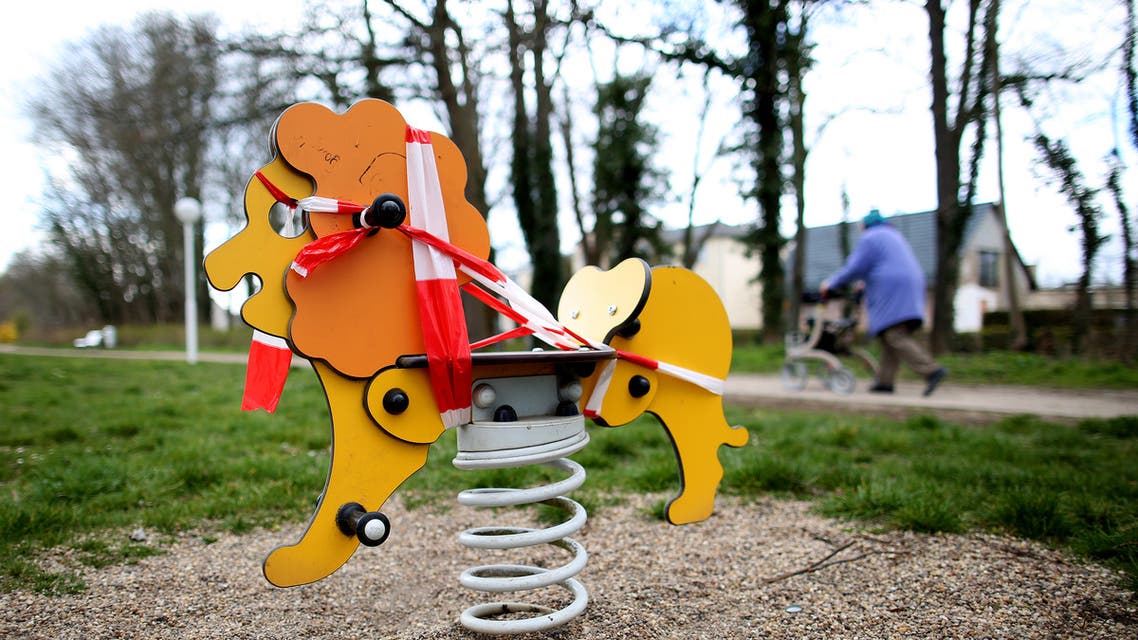Barrier tape markes the access to a swing is blocked in a closed children's playground in Schoenebeck near Magdeburg, eastern Germany, where schools are closed and other activities slowed down due to the coronavirus COVID-19 crisis, on March 31, 2020.