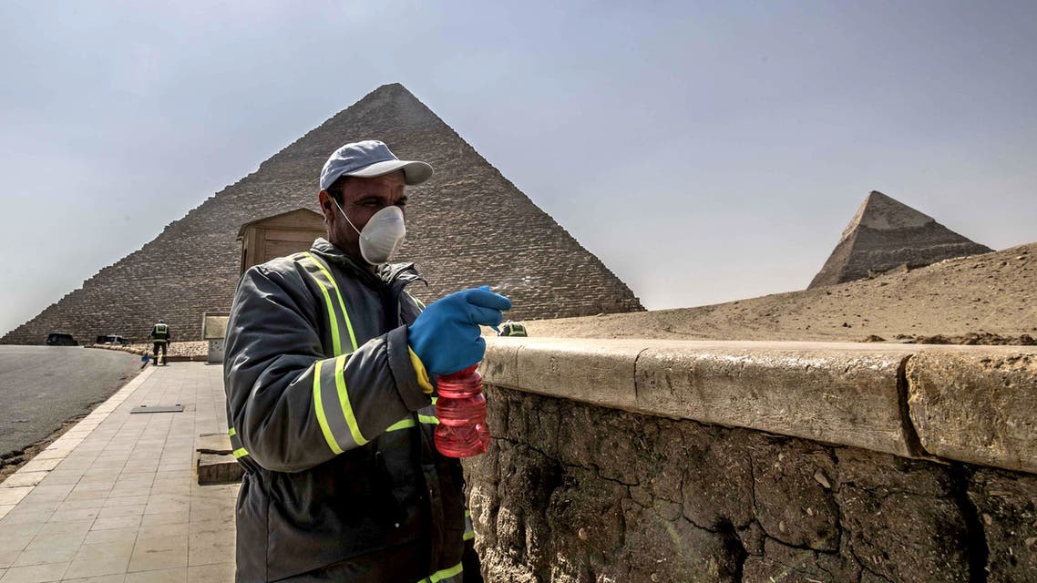 Egyptian municipality workers disinfect the Giza pyramids necropolis on the southwestern outskirts of the Egyptian capital Cairo on March 25, 2020 as protective a measure against the spread of the coronavirus COVID-19.