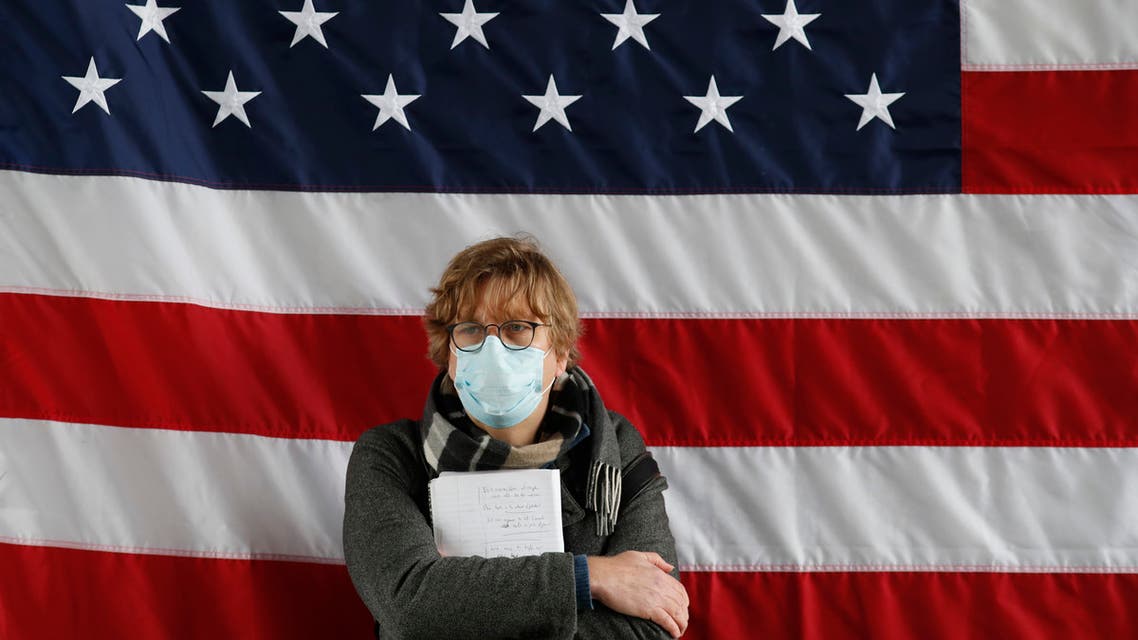 A reporter leans against the United States flag during a press briefing on March 30, 2020, in New York. (AP)