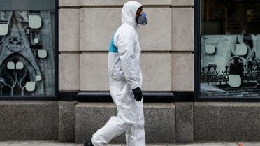 A man wears personal protective equipment (PPE) as he walks on First Avenue, during the coronavirus disease (COVID-19) outbreak, in New York City, U.S., March 31, 2020. REUTERS/Brendan McDermid