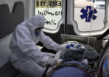 A member of emergency medical staff wearing protective suit, sits in an ambulance while transferring a patient with coronavirus disease (COVID-19) to Masih Daneshvari Hospital, in Tehran, Iran March 30, 2020. (Reuters)