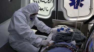 A member of emergency medical staff wearing protective suit, sits in an ambulance while transferring a patient with coronavirus disease (COVID-19) to Masih Daneshvari Hospital, in Tehran, Iran March 30, 2020. WANA (West Asia News Agency)/Ali Khara via REUTERS ATTENTION EDITORS - THIS PICTURE WAS PROVIDED BY A THIRD PARTY