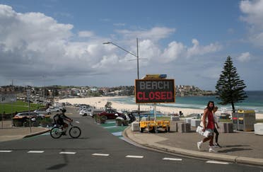 People walk past a Beach Closed sign at Bondi Beach in Sydney, Australia, April 1, 2020. (Reuters)