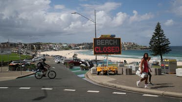 People walk past a Beach Closed sign at Bondi Beach, as the beach remains closed to prevent the spread of the coronavirus disease (COVID-19), in Sydney, Australia April 1, 2020. REUTERS/Loren Elliott