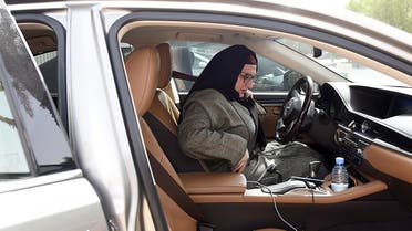 Saudi national and newly licensed Reem Farahat, an employee of Careem, a chauffeur car booking service, prepares for a customer shuttle using her car in Riyadh, on June 24, 2018. (AFP)