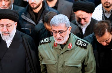 In this photo released by the official website of the Office of the Iranian Supreme Leader, Gen. Esmail Ghaani, newly appointed commander of Iran's Revolutionary Guards Quds Force, weeps while praying over the coffin of the force's previous head Gen. Qassem Soleimani at the Tehran University Campus in Tehran, Iran. (AP)