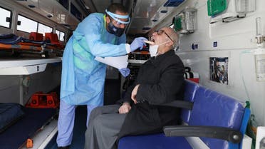 A man is treated by a Jordanian doctor as part of initiative that was launched with the aim of providing Jordanians with field medical services, amid concerns over the spread of the coronavirus disease (COVID-19), in Amman, Jordan, March 30, 2020. (Reuters)