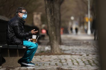 A medical worker takes a break outside of Mount Sinai Hospital amid the coronavirus pandemic on April 01, 2020 in New York City. Hospitals in New York City, the nation's current epicenter of the COVID-19 outbreak, are facing shortages of beds, ventilators and protective equipment for medical staff. (AFP) 