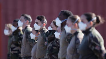 French soldiers, wearing protective face masks, attend a briefing at a miitary field hospital near Mulhouse hospital as France faces an aggressive progression of the coronavirus disease (COVID-19), March 23, 2020. REUTERS/Christian Hartmann