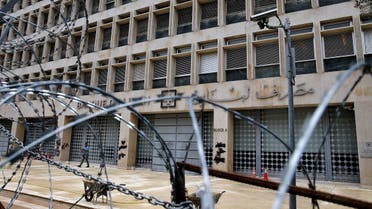 A worker walks outside the Lebanese Central Bank that has been shut down as part of the preventive measures against the coronavirus, in Beirut, Lebanon. (File photo: AP)